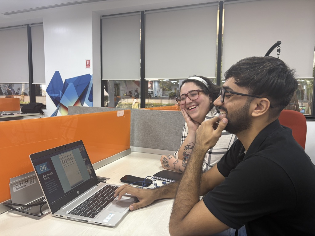 Marissa Cohen working through a presentation with a teammate at the Infosys office.